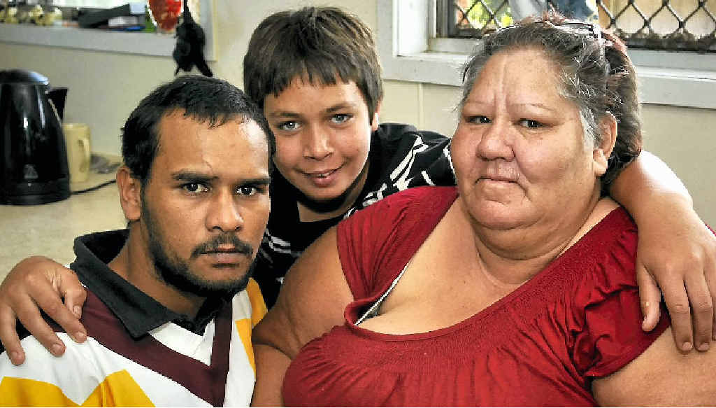 Mrs Kim “Nanna” McCarthy gets a loving hug from grandson Michael Hearn (at back) and nephew Jarret Rose at Mrs McCarthy’s Rockville home where she found another grandson and his mates had stored a large booty of stolen goods. Mrs Kim “Nanna” McCarthy gets a loving hug from grandson Michael Hearn (at back) and nephew Jarret Rose at Mrs McCarthy’s Rockville home where she found another grandson and his mates had stored a large booty of stolen goods.
