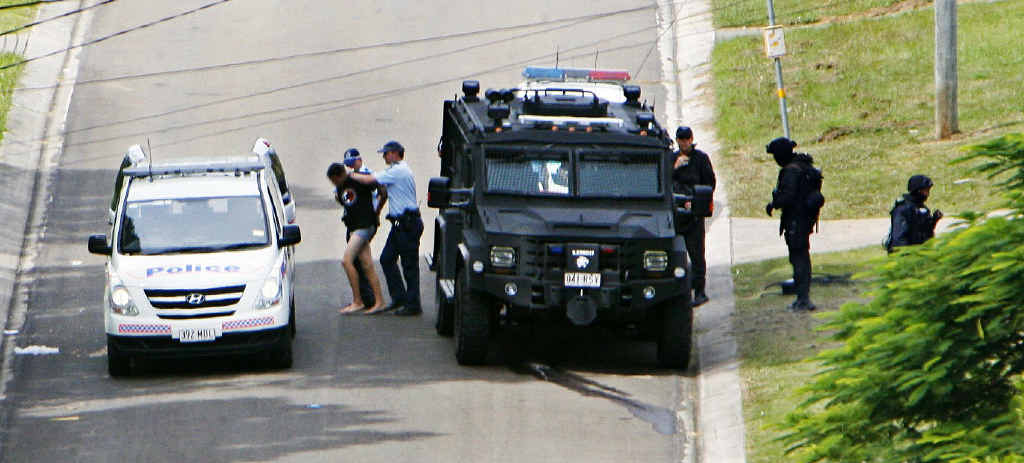 Police escort an 18-year-old man from Kanangra St, Redbank Plains, who held two women hostage for over five hours yesterday. Police escort an 18-year-old man from Kanangra St, Redbank Plains, who held two women hostage for over five hours yesterday.