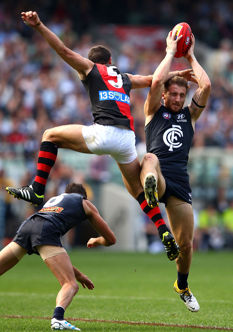 Zach Tuohy of the Blues marks under pressure from Brent Stanton of the Bombers during the round four AFL match between the Carlton Blues and the Essendon Bombers at Melbourne Cricket Ground Zach Tuohy of the Blues marks under pressure from Brent Stanton of the Bombers during the round four AFL match between the Carlton Blues and the Essendon Bombers at Melbourne Cricket Ground