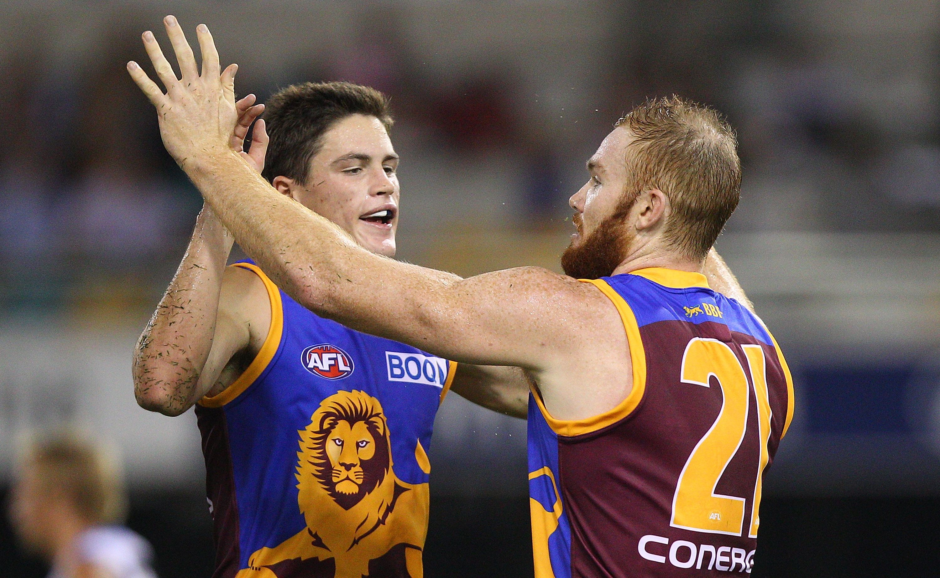 Tom Crisp and Daniel Merrett of the Lions celebrate after a goal during the round four AFL match between the Brisbane Lions and the Gold Coast Suns at The Gabba. Tom Crisp and Daniel Merrett of the Lions celebrate after a goal during the round four AFL match between the Brisbane Lions and the Gold Coast Suns at The Gabba.