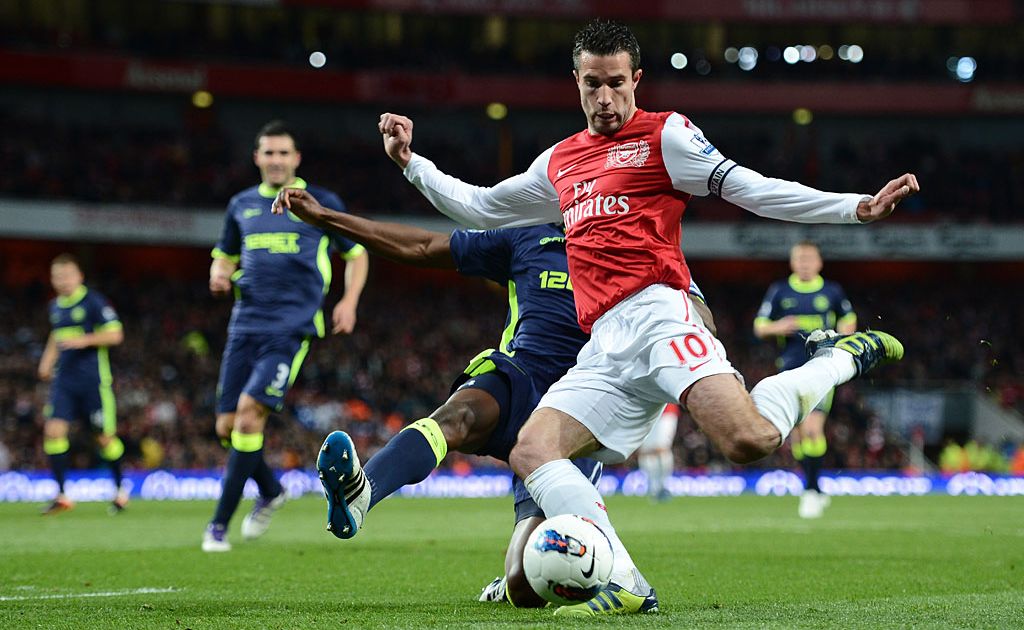 Robin van Persie of Arsenal is tackled by Emmerson Boyce of Wigan during the Barclays Premier League match between Arsenal and Wigan Athletic at Emirates Stadium on April 16, 2012 in London, England. Robin van Persie of Arsenal is tackled by Emmerson Boyce of Wigan during the Barclays Premier League match between Arsenal and Wigan Athletic at Emirates Stadium on April 16, 2012 in London, England.