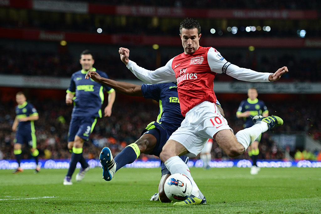 Robin van Persie of Arsenal is tackled by Emmerson Boyce of Wigan during the Barclays Premier League match between Arsenal and Wigan Athletic at Emirates Stadium on April 16, 2012 in London, England. Robin van Persie of Arsenal is tackled by Emmerson Boyce of Wigan during the Barclays Premier League match between Arsenal and Wigan Athletic at Emirates Stadium on April 16, 2012 in London, England.