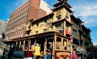 A cable car passes the landmark 1908 Sing Chong Building in Chinatown, San Francisco.
A cable car passes the landmark 1908 Sing Chong Building in Chinatown, San Francisco.