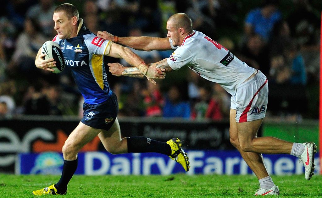 Brent Tate of the Cowboys is tackled by Gavin Cooper of the Dragons. Brent Tate of the Cowboys is tackled by Gavin Cooper of the Dragons.