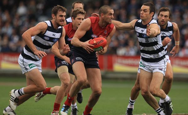 James Sellar of the Demons collects the ball under pressure from Matthew Scarlett (R) of the Cats during the round six AFL match between the Geelong Cats and the Melbourne Demons at Simonds Stadium. James Sellar of the Demons collects the ball under pressure from Matthew Scarlett (R) of the Cats during the round six AFL match between the Geelong Cats and the Melbourne Demons at Simonds Stadium.