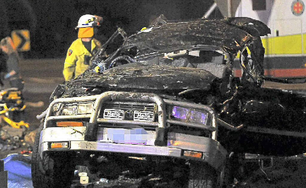 The wreck of the four-wheel-drive that crashed at the Coolum roundabout, at left, on the Sunshine Coast Motorway. The wreck of the four-wheel-drive that crashed at the Coolum roundabout, at left, on the Sunshine Coast Motorway.