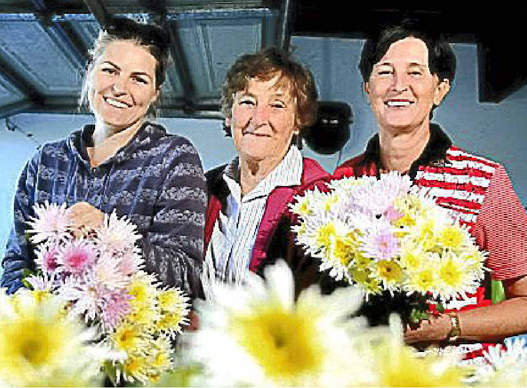 Elisha Damro, Marge Mitchell and Marion Stehn work at the flower farm.