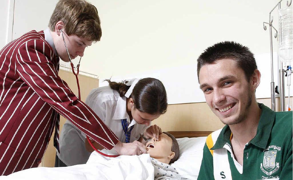 Aspiring doctors IGS student Chris Goode and Bremer student Kayley Taaffe (back) with Lowood nurse hopeful Chad Clark (front) at the Ipswich Hospital. Aspiring doctors IGS student Chris Goode and Bremer student Kayley Taaffe (back) with Lowood nurse hopeful Chad Clark (front) at the Ipswich Hospital.