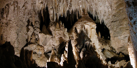 Stalactites hang into the cave like like tapering organ pipes.
Stalactites hang into the cave like like tapering organ pipes.