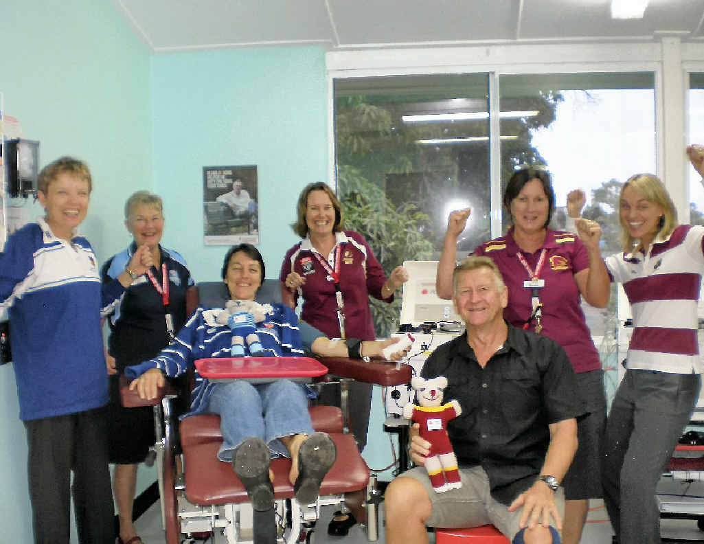 Margaret Black, Vicki Olsen, Stephanie Cairns, Bernice Chapman and Hollie Hall with Blues supporter, donor, Linda Casey and Maroons fan Reg Pugh. Margaret Black, Vicki Olsen, Stephanie Cairns, Bernice Chapman and Hollie Hall with Blues supporter, donor, Linda Casey and Maroons fan Reg Pugh.
