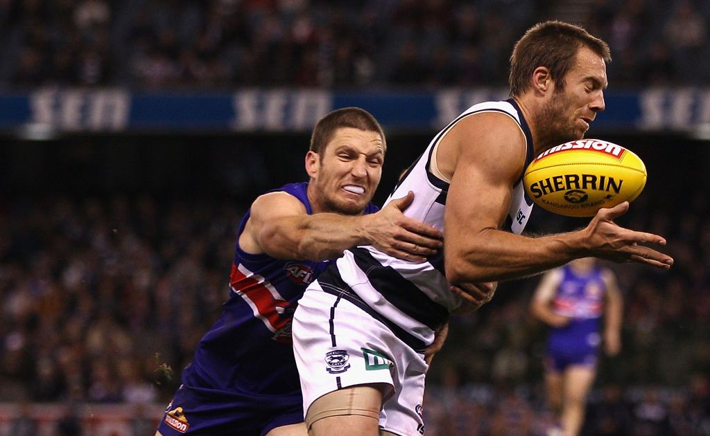 Joel Corey of the Cats is tackled by Matthew Boyd of the Bulldogs during the round nine AFL match between the Western Bulldogs and the Geelong Cats at Etihad Stadium Joel Corey of the Cats is tackled by Matthew Boyd of the Bulldogs during the round nine AFL match between the Western Bulldogs and the Geelong Cats at Etihad Stadium