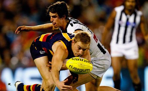 Bernie Vince of Crows tries to handpass while being tackled by Scott Pendlebury of Magpies during the round nine AFL match between the Adelaide Crows and the Collingwood Magpies at AAMI Stadium.
