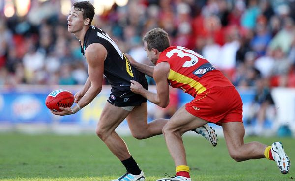 Ben Jacobs of the Power is tackled by Sam Iles of the Suns during the round nine AFL match between the Gold Coast Suns and Port Adelaide Power at Metricon Stadium. Ben Jacobs of the Power is tackled by Sam Iles of the Suns during the round nine AFL match between the Gold Coast Suns and Port Adelaide Power at Metricon Stadium.