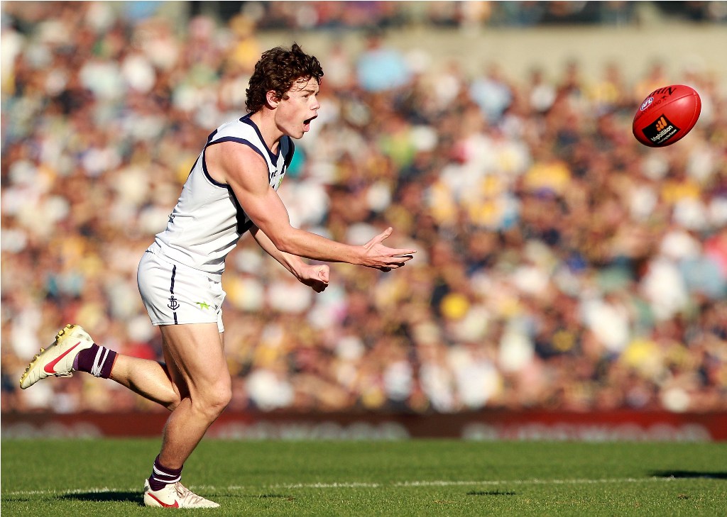 Lachie Neale of the Dockers handballs during the round nine AFL match between the West Coast Eagles and the Fremantle Dockers at Patersons Stadium on May 27, 2012 in Perth, Australia. Lachie Neale of the Dockers handballs during the round nine AFL match between the West Coast Eagles and the Fremantle Dockers at Patersons Stadium on May 27, 2012 in Perth, Australia.
