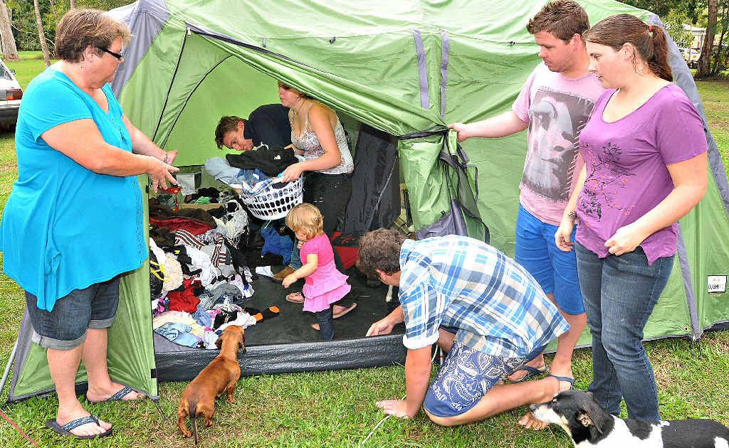 Showing the daily struggle of living in a tent are (from left) Theresa Holtham, Justin Dean, Amanda Holtham, Charlotte Holtham, John Holtham, Richard Holtham and Chenelle Holtham with dogs Sausage and Foxy. Showing the daily struggle of living in a tent are (from left) Theresa Holtham, Justin Dean, Amanda Holtham, Charlotte Holtham, John Holtham, Richard Holtham and Chenelle Holtham with dogs Sausage and Foxy.