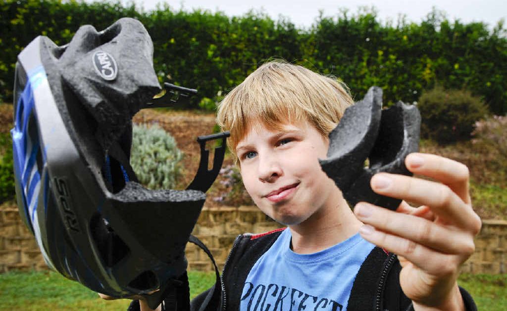 Braden Cooper, 12, shows off the large chunk taken out of his helmet after he had a bike accident last year. Braden Cooper, 12, shows off the large chunk taken out of his helmet after he had a bike accident last year.