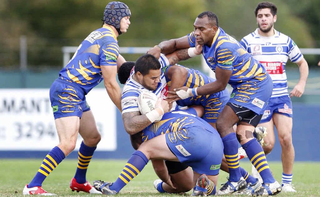 Josh Roberts and Desmond Mok struggle with Tigers team mates to contain Sione Piutau during Brothers’ demolition of Norths yesterday at Raceview. Full IRL wrap on Page 26. Josh Roberts and Desmond Mok struggle with Tigers team mates to contain Sione Piutau during Brothers’ demolition of Norths yesterday at Raceview. Full IRL wrap on Page 26.