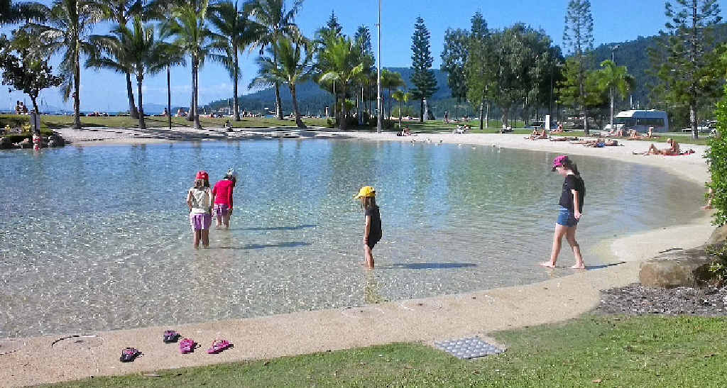 The girls paddle in the Lagoon at the Airlie Beach boardwalk. The girls paddle in the Lagoon at the Airlie Beach boardwalk.