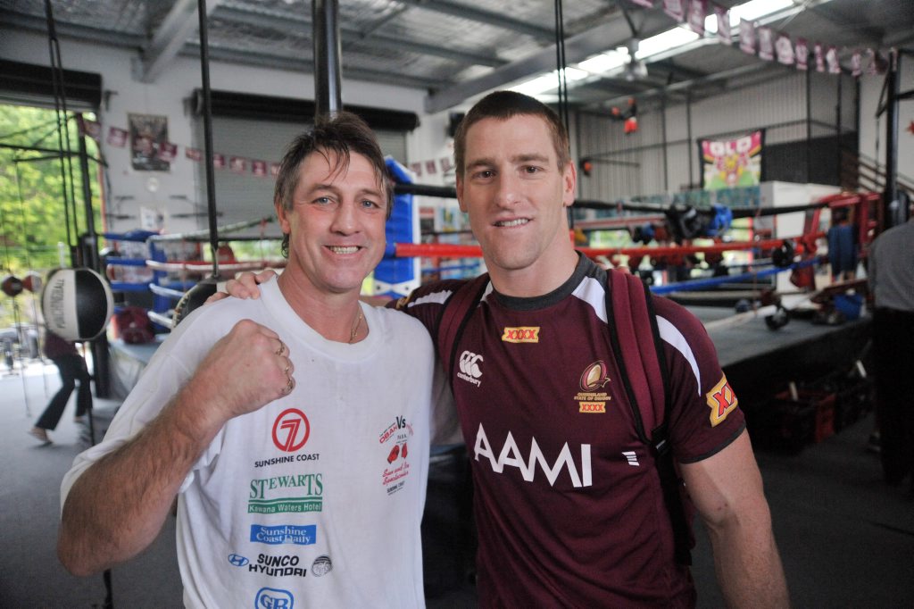 The Maroons’ Brent Tate, right, rubs shoulders with Darren Obah at the former professional boxer’s gym at Kunda Park. The Maroons’ Brent Tate, right, rubs shoulders with Darren Obah at the former professional boxer’s gym at Kunda Park.