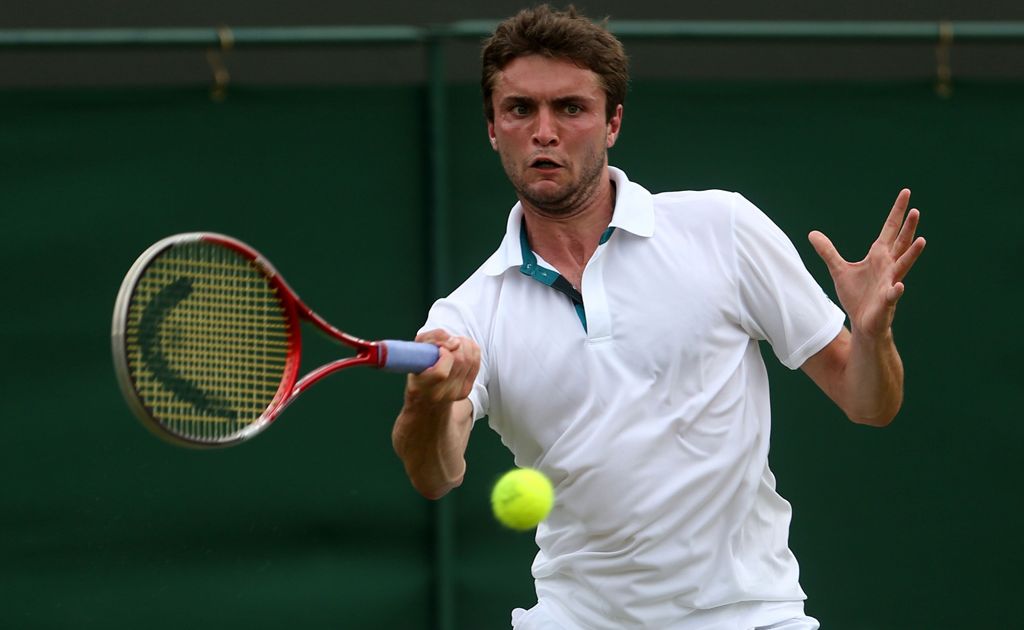 Gilles Simon of France hits a forehand return during his Gentlemen's Singles second round match against Xavier Malisse of Belgium on day four of the Wimbledon Lawn Tennis Championships at the All England Lawn Tennis and Croquet Club Gilles Simon of France hits a forehand return during his Gentlemen's Singles second round match against Xavier Malisse of Belgium on day four of the Wimbledon Lawn Tennis Championships at the All England Lawn Tennis and Croquet Club