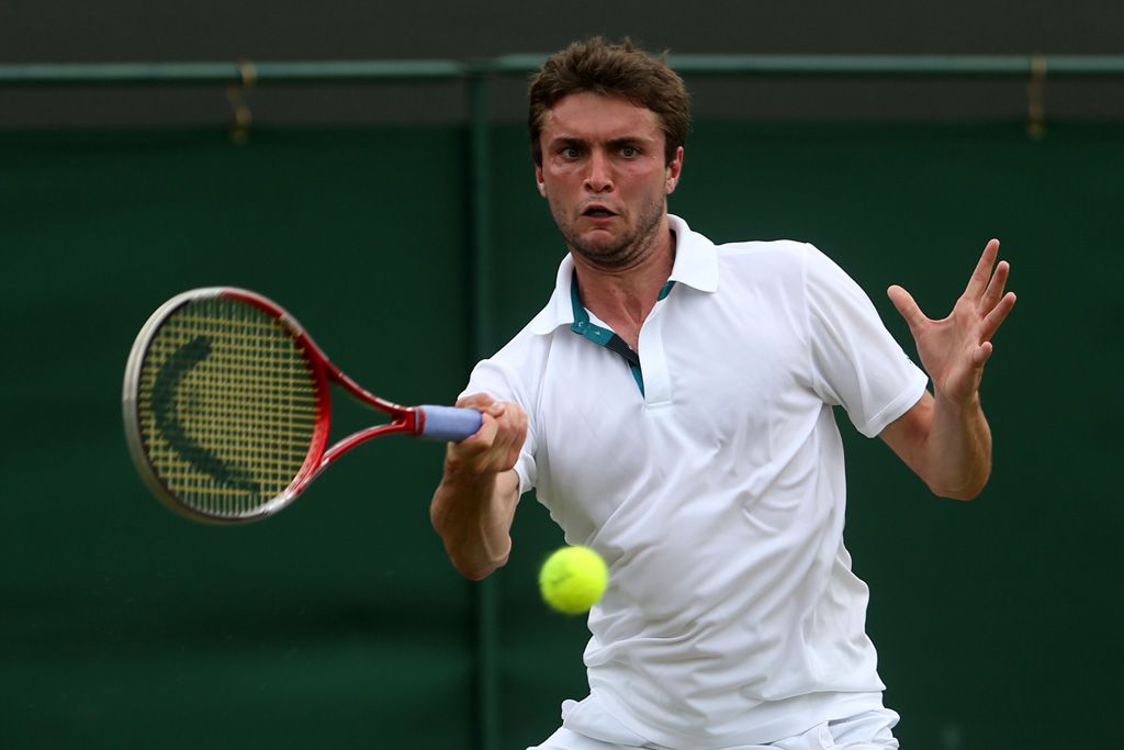 Gilles Simon of France hits a forehand return during his Gentlemen's Singles second round match against Xavier Malisse of Belgium on day four of the Wimbledon Lawn Tennis Championships at the All England Lawn Tennis and Croquet Club Gilles Simon of France hits a forehand return during his Gentlemen's Singles second round match against Xavier Malisse of Belgium on day four of the Wimbledon Lawn Tennis Championships at the All England Lawn Tennis and Croquet Club