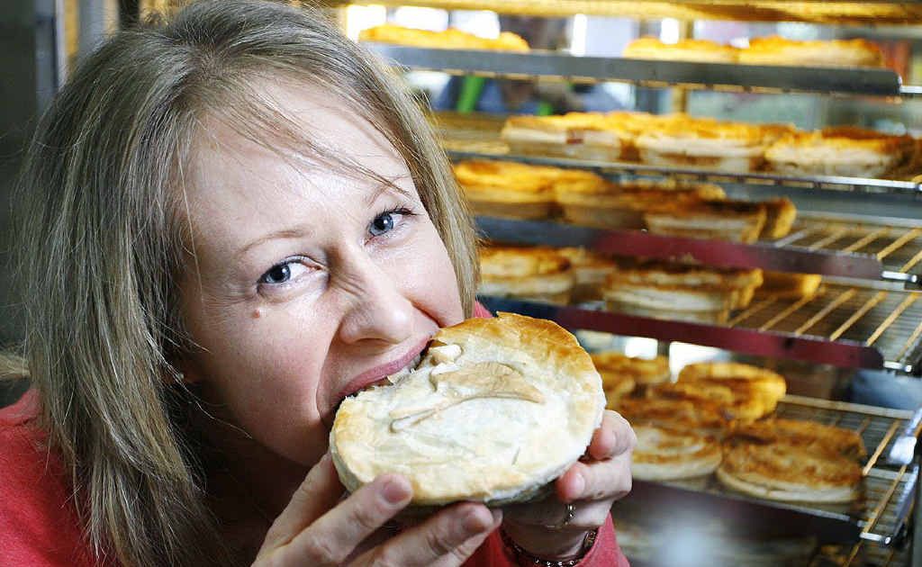 Lisa Barry tucks into a kangaroo pie. Also on sale are crocodile, emu, venison and camel pies. Photo: Claudia Baxter Lisa Barry tucks into a kangaroo pie. Also on sale are crocodile, emu, venison and camel pies. Photo: Claudia Baxter