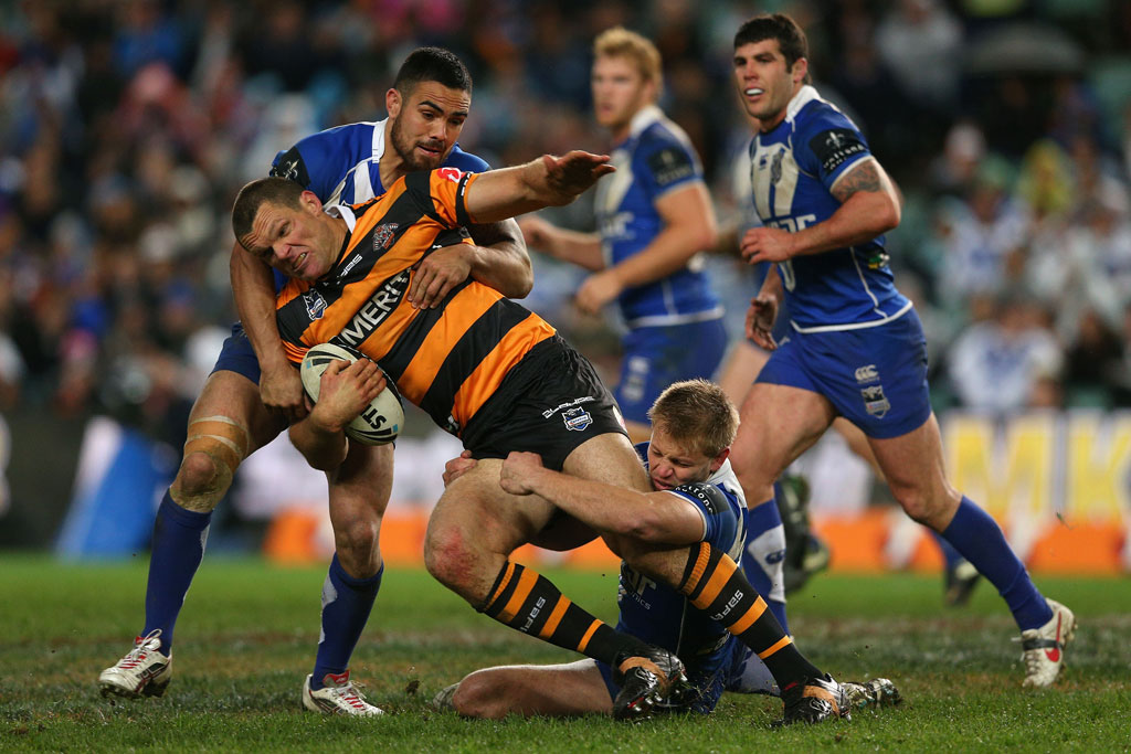 Ray Cashmere of the Tigers is tackled during the round 18 NRL match between the Wests Tigers and the Canterbury Bulldogs at Allianz Stadium Ray Cashmere of the Tigers is tackled during the round 18 NRL match between the Wests Tigers and the Canterbury Bulldogs at Allianz Stadium