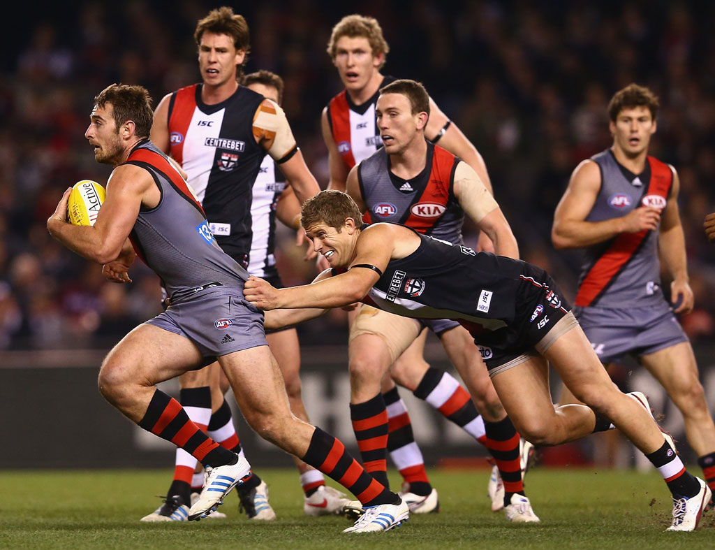 Jobe Watson of the Bombers is tackled by Nick Dal Santo of the Saints during the round 15 AFL match between the St Kilda Saints and the Essendon Bombers at Etihad Stadium Jobe Watson of the Bombers is tackled by Nick Dal Santo of the Saints during the round 15 AFL match between the St Kilda Saints and the Essendon Bombers at Etihad Stadium