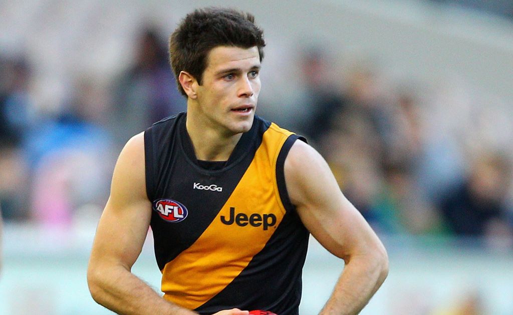 Trent Cotchin of the Tigers runs with the ball during the round 15 AFL match between the Melbourne Demons and the Richmond Tigers at the Melbourne Cricket Ground Trent Cotchin of the Tigers runs with the ball during the round 15 AFL match between the Melbourne Demons and the Richmond Tigers at the Melbourne Cricket Ground