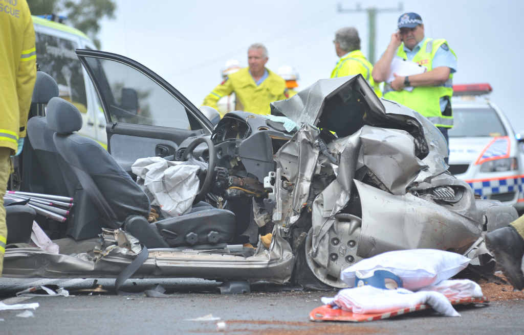 Paramedics and emergency crews work on the female driver of a car involved in a head-on crash on Thursday. Paramedics and emergency crews work on the female driver of a car involved in a head-on crash on Thursday.
