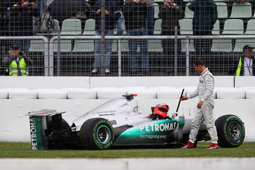 Michael Schumacher of Germany and Mercedes GP stands with his car after he span and crashed out during practice for the German Grand Prix at Hockenheimring Michael Schumacher of Germany and Mercedes GP stands with his car after he span and crashed out during practice for the German Grand Prix at Hockenheimring