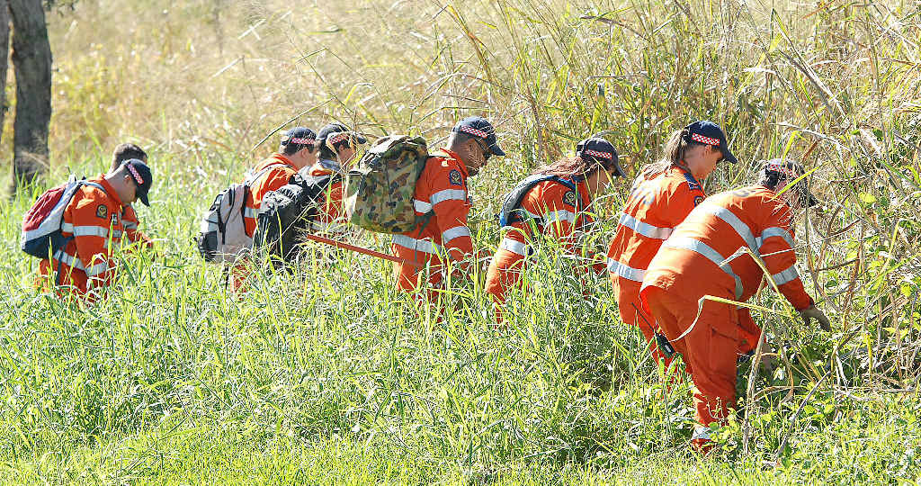 SES volunteers search through grassland at Mt Pleasant for evidence during a police operation in Mackay investigating the disappearance of Timothy Pullen. SES volunteers search through grassland at Mt Pleasant for evidence during a police operation in Mackay investigating the disappearance of Timothy Pullen.
