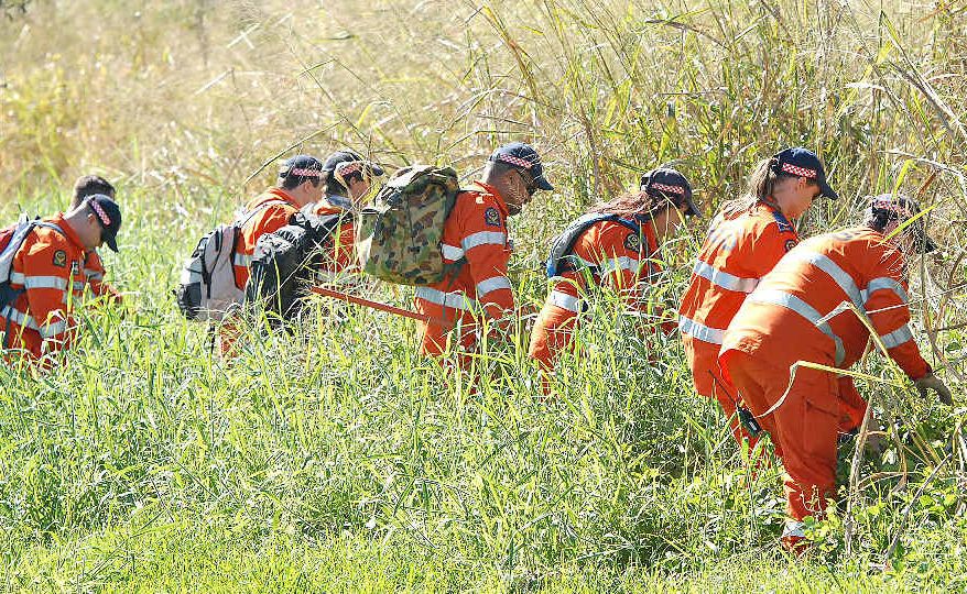 SES volunteers search through grassland at Mt Pleasant for evidence during a police operation in Mackay investigating the disappearance of Timothy Pullen. SES volunteers search through grassland at Mt Pleasant for evidence during a police operation in Mackay investigating the disappearance of Timothy Pullen.