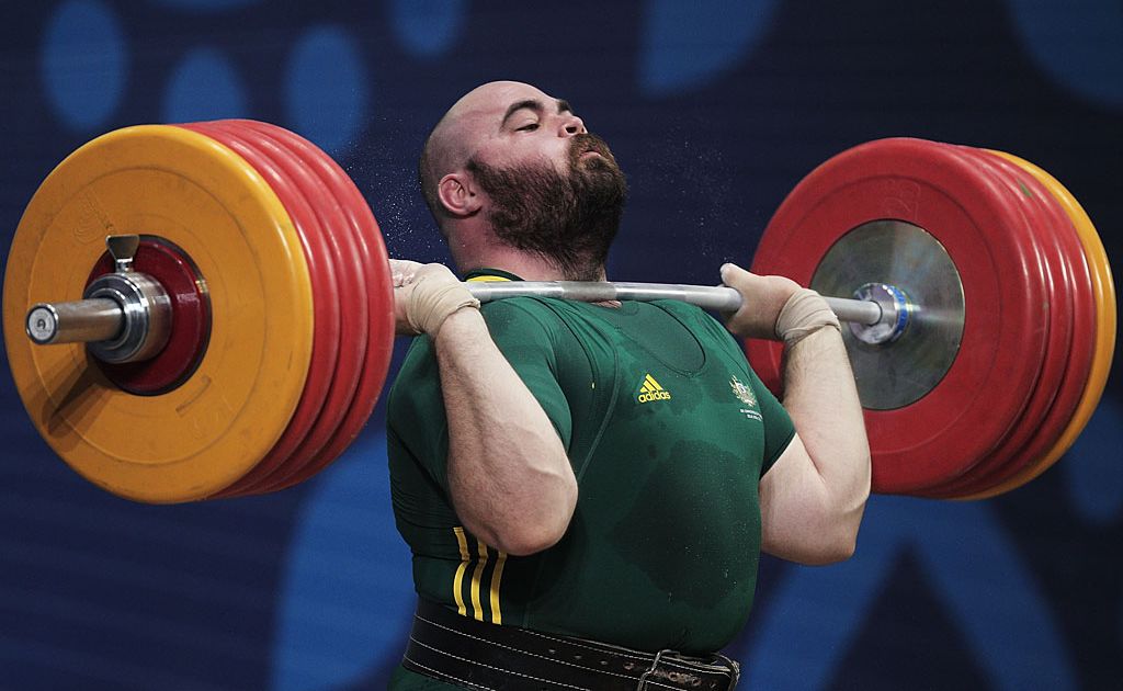 Damon Kelly of Australia lifts in the Clean and Jerk on his way to winning the Gold Medal in the mens 105+kg Weightlifting competition at JN Sports Complex during day eight of the Delhi 2010 Commonwealth Games on October 11, 2010 in Delhi, India. Damon Kelly of Australia lifts in the Clean and Jerk on his way to winning the Gold Medal in the mens 105+kg Weightlifting competition at JN Sports Complex during day eight of the Delhi 2010 Commonwealth Games on October 11, 2010 in Delhi, India.