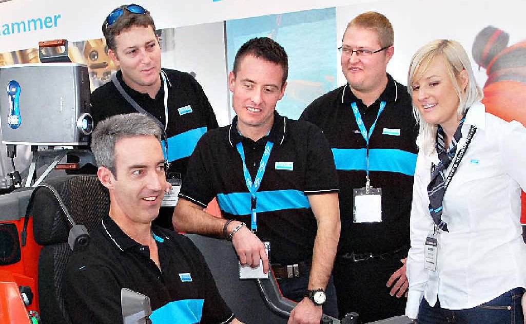 Sandvik staff (from left) Jason Cross, Craig Elgar, Michael Zirbel, Andrew Atkinson and Kate Bills try out the Sim Driller, a simulator-based training system. Sandvik staff (from left) Jason Cross, Craig Elgar, Michael Zirbel, Andrew Atkinson and Kate Bills try out the Sim Driller, a simulator-based training system.