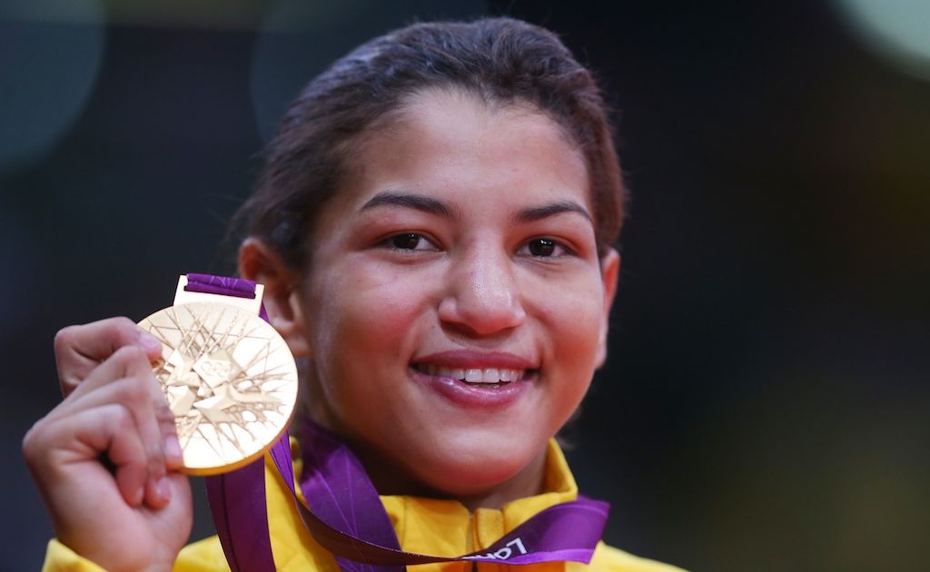 Brazilian Sarah Menezes defeated defending champion Alina Dumitru to win gold in the women's extra lightweight 48 kilogram judo event. Brazilian Sarah Menezes defeated defending champion Alina Dumitru to win gold in the women's extra lightweight 48 kilogram judo event.