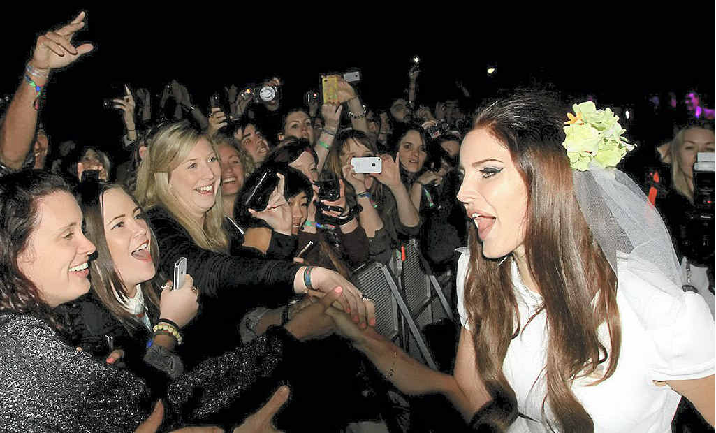 Lana Del Rey wearing a wedding dress gets close and personal with fans. Lana Del Rey wearing a wedding dress gets close and personal with fans.