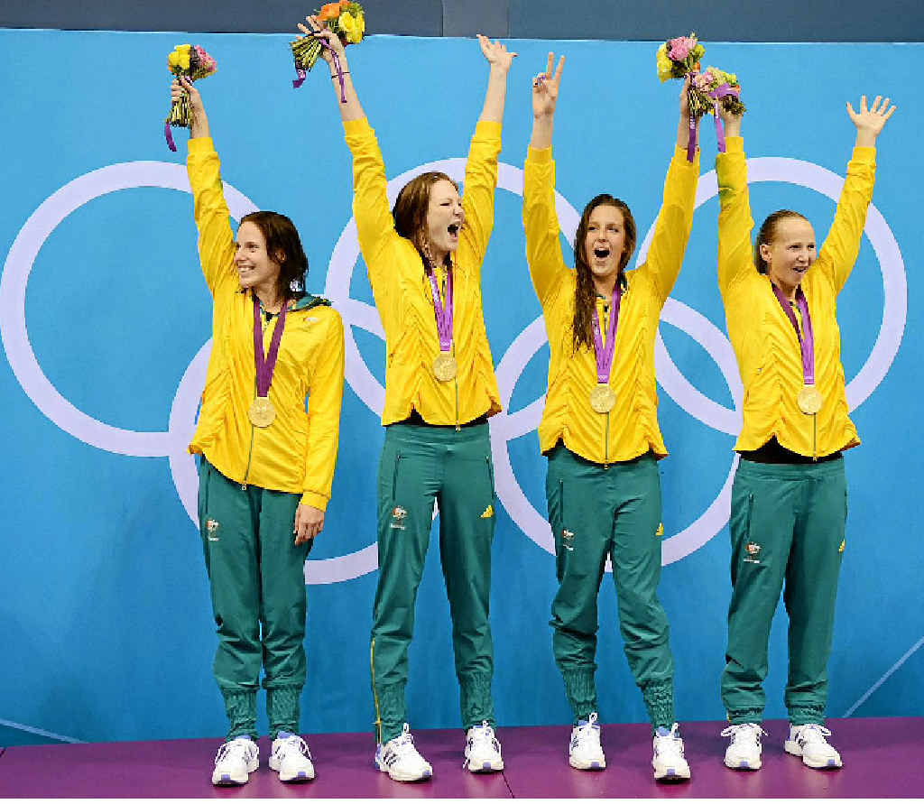 Brittany Elmslie (second from right) and Melanie Schlanger (right) celebrate with Alicia Coutts and Cate Campbell on the podium after winning the women's 4 x 100m freestyle relay final in Olympic record time. Brittany Elmslie (second from right) and Melanie Schlanger (right) celebrate with Alicia Coutts and Cate Campbell on the podium after winning the women's 4 x 100m freestyle relay final in Olympic record time.