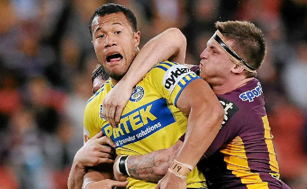 Joseph Paulo of the Eels is tackled by a couple of Broncos during their NRL match at Suncorp Stadium. Joseph Paulo of the Eels is tackled by a couple of Broncos during their NRL match at Suncorp Stadium.