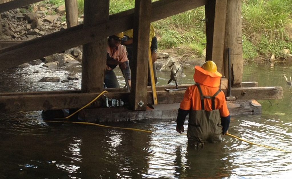 Workers brave the water in Amamoor Creek. Workers brave the water in Amamoor Creek.