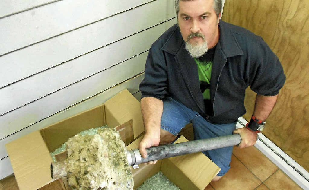 The Capricorn Model House shop manager Shane Davey with the pipe set in concrete that teens allegedly used to smash into the premises. The Capricorn Model House shop manager Shane Davey with the pipe set in concrete that teens allegedly used to smash into the premises.