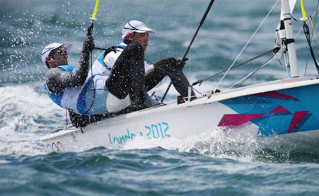 Malcolm Page (left), with gold medal winning partner Mathew Belcher, will carry the Australian flag at the closing ceremony. Malcolm Page (left), with gold medal winning partner Mathew Belcher, will carry the Australian flag at the closing ceremony.