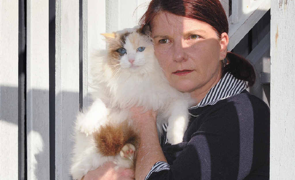 Julie Marshall keeps her cat 'Teacup' close after the shock of finding her other pet cat 'Pyjamas' shot and dying in her front yard on Sunday. Julie Marshall keeps her cat 'Teacup' close after the shock of finding her other pet cat 'Pyjamas' shot and dying in her front yard on Sunday.