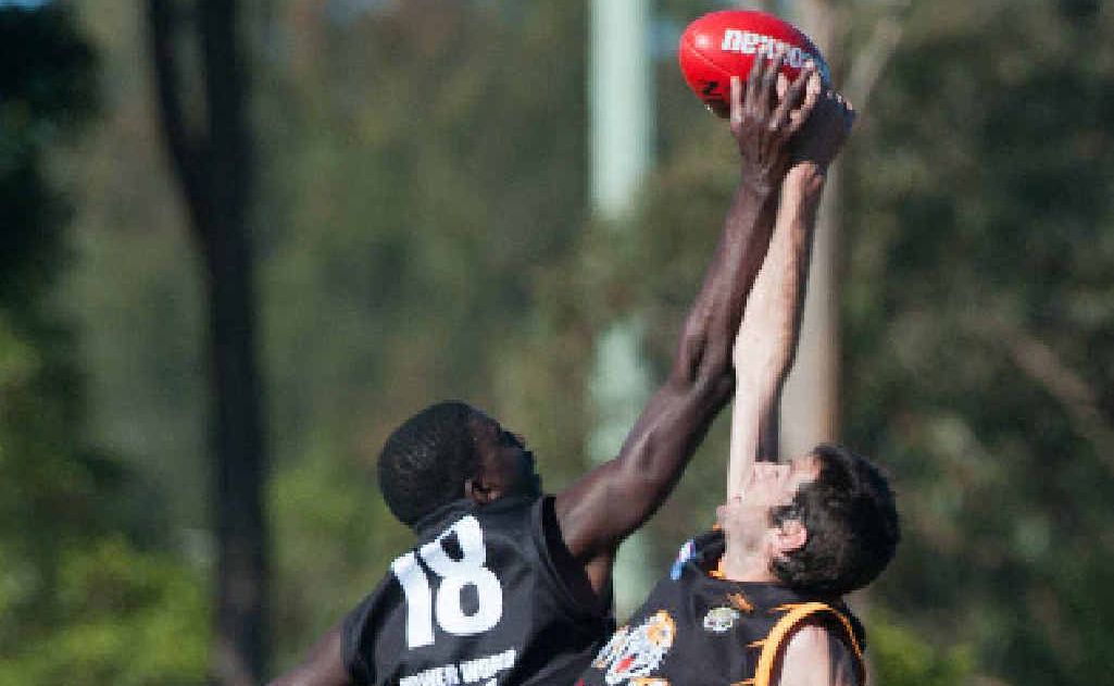 A Port Macquarie player tries to hit the ball clear from a Grafton Tigers rival during the qualifying final match at BCU Stadium on Saturday. A Port Macquarie player tries to hit the ball clear from a Grafton Tigers rival during the qualifying final match at BCU Stadium on Saturday.
