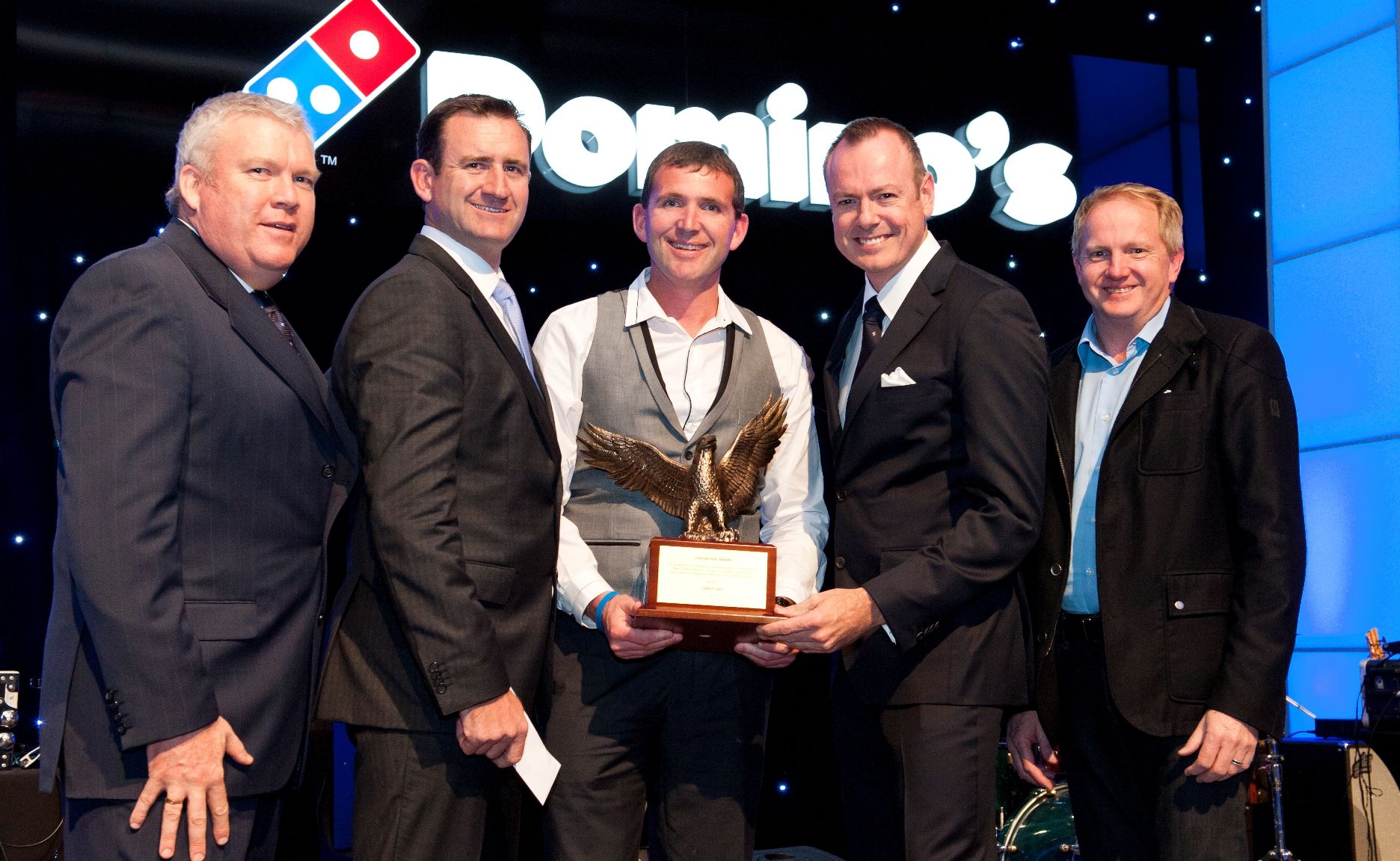 Leroy Day (centre) with his Domino's Pizza Leadership Eagle award. Leroy Day (centre) with his Domino's Pizza Leadership Eagle award.
