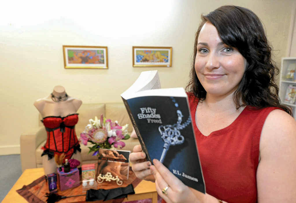 Bek McKenzie, manager of Purely Venus, with one of the 50 Shades of Grey books encouraging women to try new intimate items.