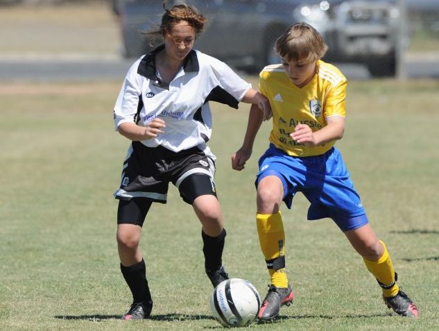 Grand finals weekend - soccer - Sandy Straits versus Doon Villa - Doon Villa's Lilly Elliott and Sandy Straits' Jarrod Best. Photo: Valerie Horton / Fraser Coast Chronicle