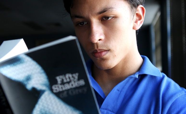 Student Michael Strickland reading popular erotic novel Fifty Shades of Grey. Student Michael Strickland reading popular erotic novel Fifty Shades of Grey.