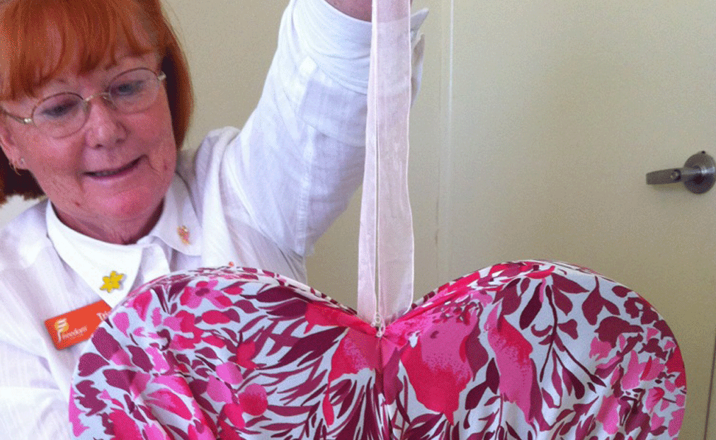 Freedom Aged Care diversional therapist Trish Lockhart shows one of the hearts that feature on their float for the Carnival of Flowers grand parade. 