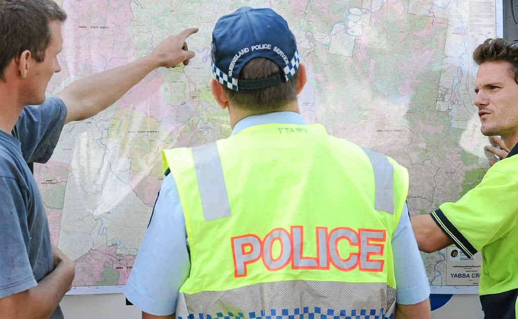 Locals discuss terrain with police at the Kenilworth Showgrounds forward control base on Tuesday. Locals discuss terrain with police at the Kenilworth Showgrounds forward control base on Tuesday.